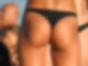 Fit girl with nice body in thong bikini on the beach