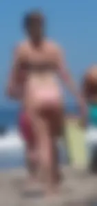 Chunky beach blonde babe in a pink thong bikini