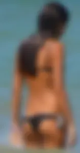 Tight bodied skinny brunette on the beach in a bikini