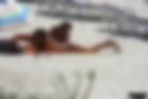 Topless milf and her topless daughter on the beach