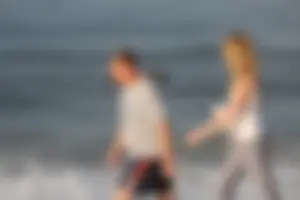 Skinny blonde on the beach in tight grey leggings