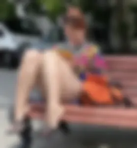 Mature Redhead in a Dress Flashing Panties While Sitting on a Street Bench