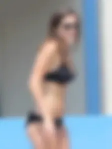 Sexy girl at the pool in a black bikini with nice body