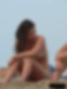 Sexy babe with a nice body topless and in a thong on the beach