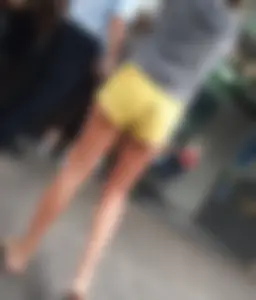 Skinny ass eating her yellow shorts