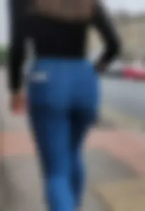 Brunette beauty with a slender waist in tight jeans