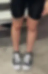 Slim Female Legs in Spandex Shorts Street Closeup