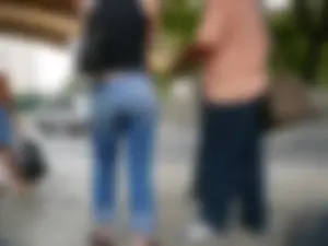 Red haired lady with a nice ass in tight jeans waiting for the bus