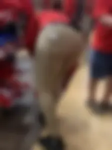 Bunch of girls in various outfits at a Cardinals baseball game