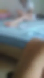 Candid barefoot girl in a T-shirt sitting in bed home sneaky photo
