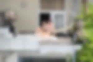 Neighbor on rooftop tanning in bikinis