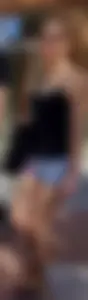 Cute girl with glasses in USA shorts showing her cheeks