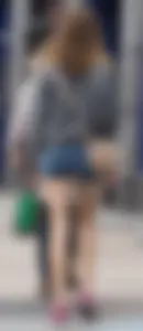 Smiling, slim and sexy in her shorts