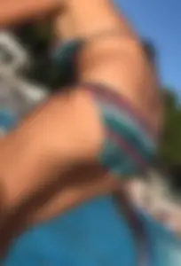 Patterned bikini ass bending over at the pool