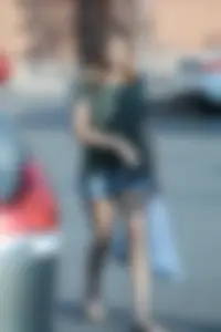 Cutie walking in the parking lot in jean shorts
