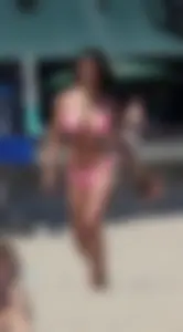 Sexy brunette on the beach in a bikini with great tits