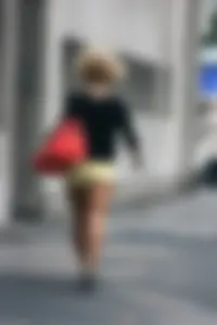 Blonde looking sexy walking in short yellow shorts