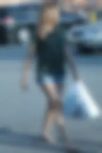 Cutie walking in the parking lot in jean shorts