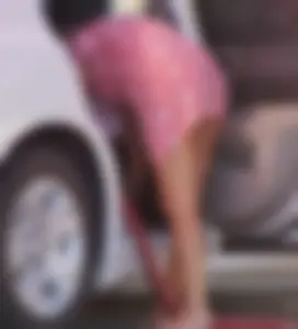 Sexy blonde upskirted in pink dress while cleaning her car