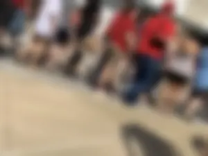 Bunch of girls in various outfits at a Cardinals baseball game