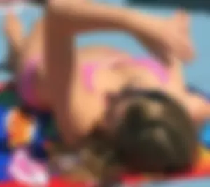 Couple of sexy teen friends laying out in bikinis
