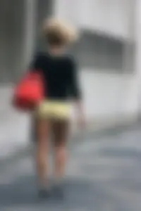 Blonde looking sexy walking in short yellow shorts