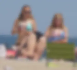 3 girls on the beach in bikinis with big boobs, one brunette and two blondes