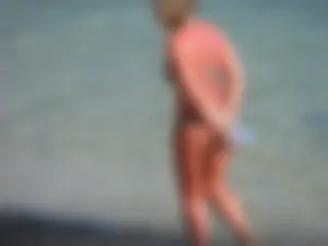 Blonde milf on the beach in her bikini