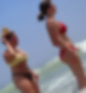 Thick girl and her skinny friend in bikinis at the beach