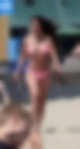 Sexy brunette on the beach in a bikini with great tits