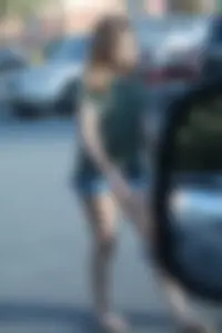 Cutie walking in the parking lot in jean shorts