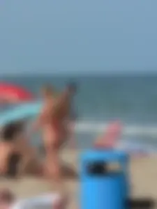 Sexy mom and daughter in red thongs at the beach