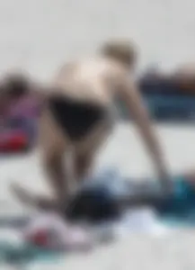 Big boobed thick blonde on the beach in a bikini