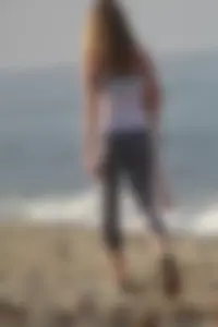 Skinny blonde on the beach in tight grey leggings