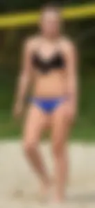 Cute girl playing volleyball in her little bikini