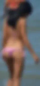 Little brunette ass in a pink bikini at the beach