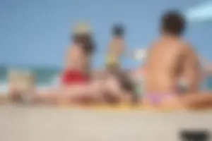 2 topless girls at the beach in thongs