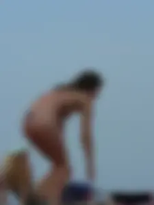 Sexy babe with a nice body topless and in a thong on the beach