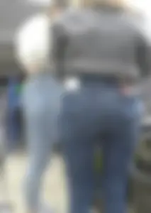 Two hot milfs in tight blue jeans standing at the cash register at the supermarket, awesome big butts