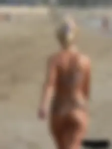 Tattooed blonde with big tits topless and in thong