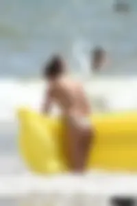 Blue thong lady in the water with a float