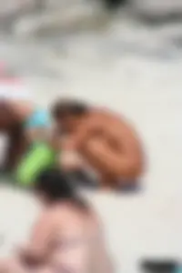 Older lady on a nude beach showing her body