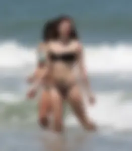 Brunette and redhead on the beach in bikinis looking sexy