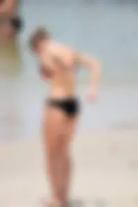 Sexy chick in red and black bikini on the beach