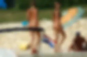 Two sexy nude beach friends getting some sun