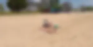 Girl laying out getting sun in a white thong bikini