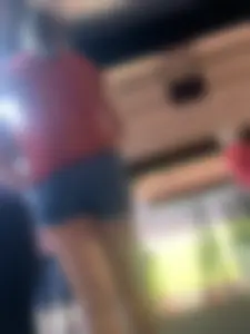 Bunch of girls in various outfits at a Cardinals baseball game