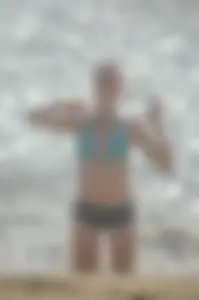 Blonde lady on the beach in bikini top and spandex shorts with a nice gap