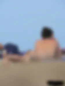 Sexy babe with a nice body topless and in a thong on the beach