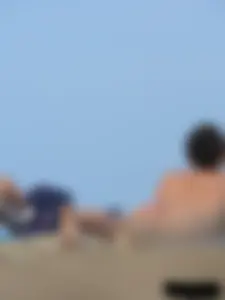 Sexy babe with a nice body topless and in a thong on the beach